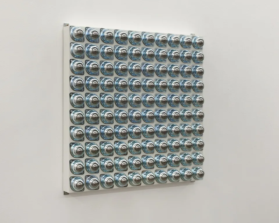 An angled view of the circular metal fittings panel