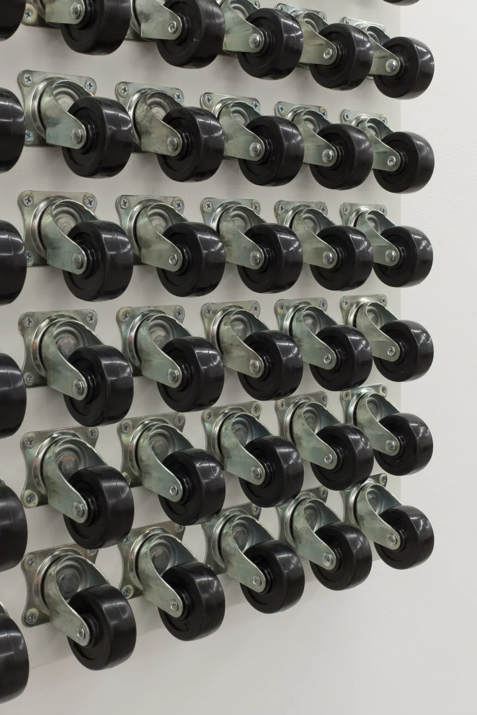 Oblique close view of rows of caster wheels