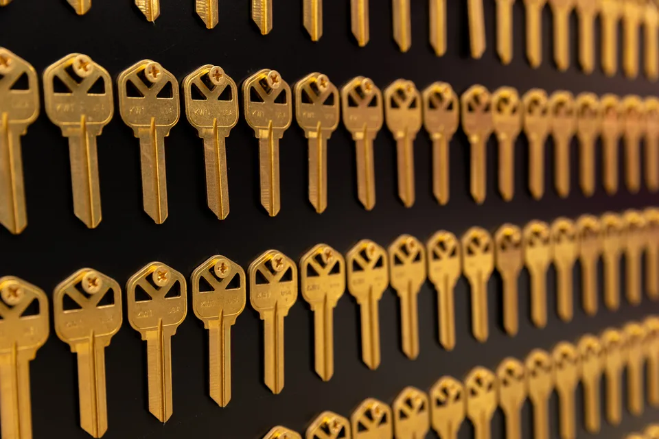 Rows of brass keys are mounted on a black square panel.