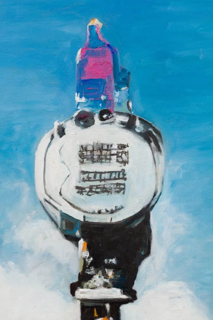 Detail of a painted mechanical object with a white circular dial against blue sky.