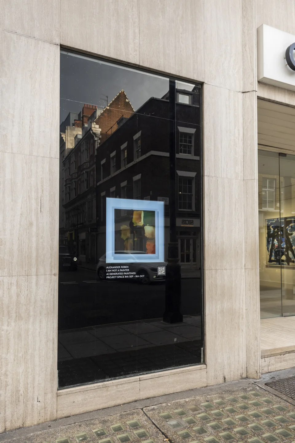 The gallery window screen shows a small image within a pale blue frame above the exhibition announcement.